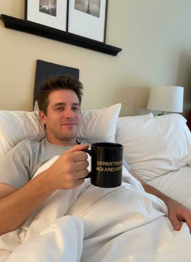 Man Holding Object in Bed