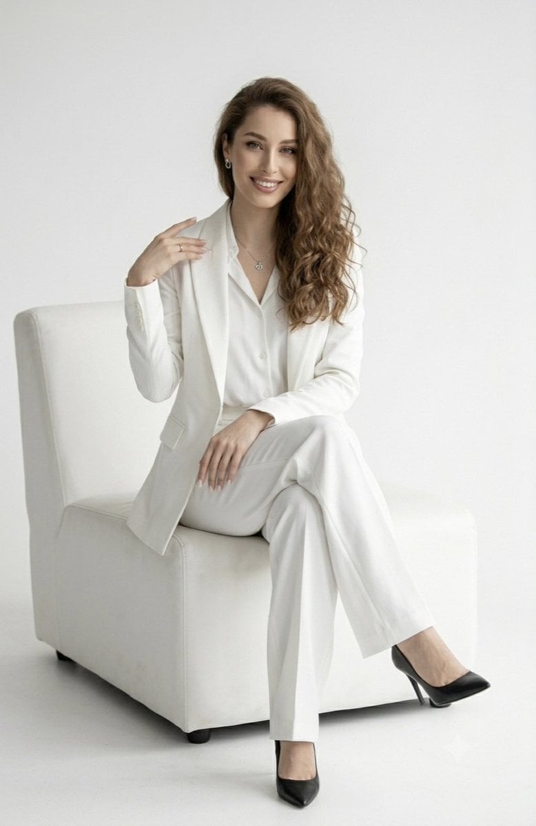 Elegant Woman in White Pantsuit